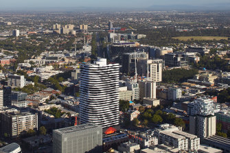 Barakâ€™s image towers over Swanston Street on the facade of a Melbourne apartment building.