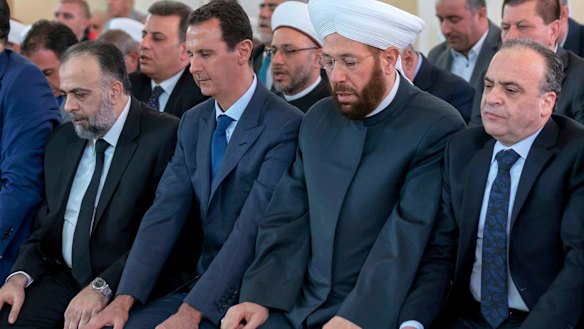 Syrian President Bashar al-Assad, second from left, prays on the first day of Eid al-Adha at al-Rawda mosque, in Damascus, Syria, last week.