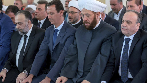 Syrian President Bashar al-Assad, second from left, prays on the first day of Eid al-Adha at al-Rawda mosque, in Damascus, Syria, last week.