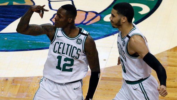 Boston Celtics' Terry Rozier (left) celebrates with Jayson Tatum after nailing a three-pointer.