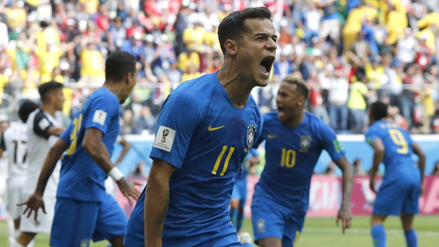 Leaving it late: Philippe Coutinho celebrates his injury time goal.