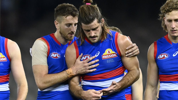 Marcus Bontempelli consoles Josh Bruce after his injury, and after the loss to Essendon. 