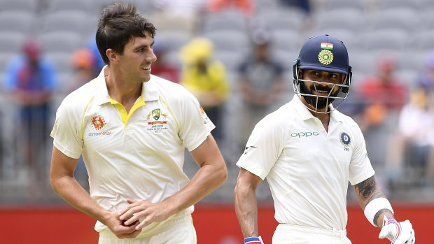 Fair play: Indian captain shares a smile with Australian paceman Pat Cummins on day three.