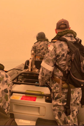 HMAS Choules Commander Scott Houlihan leads a liaison team to meet with community leaders in Mallacoota.