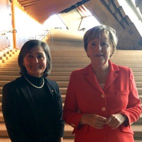 Herron and former German chancellor Angela Merkel.