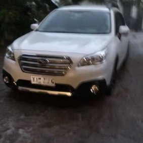 Water lapped at the wheels of cars parked in the Yeerongpilly driveway.