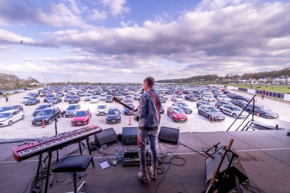 Danish musician Mads Langer performs to an audience in socially distanced cars.