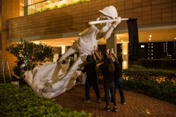 University students move a statue of Lady Liberty last month.