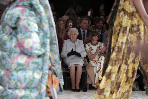 Queen Elizabeth sits next to Vogue’s Anna Wintour as they view Richard Quinn’s runway show before presenting him with the inaugural Queen Elizabeth II Award for British Design in 2018.