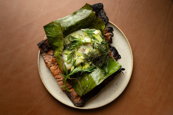 Paperbark package filled with leek, lovage, Monforte cheese and finger lime.