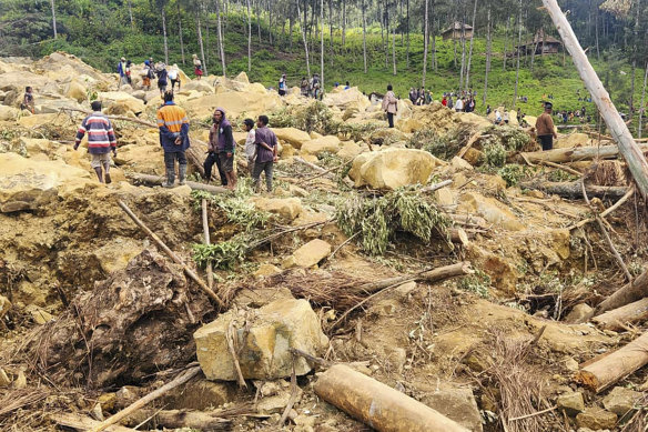Villagers search landslide debris in the village of Yambali, PNG.