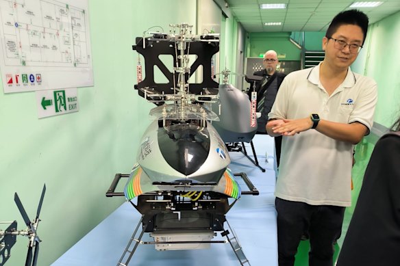 Allan Chi of Thunder Tiger, a drone manufactuer in Taiwan, next to one of the company’s TTRobotix.
