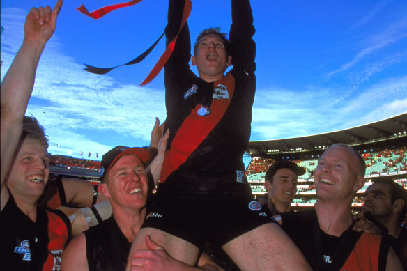 James Hird holds the 2000 premiership cup aloft.