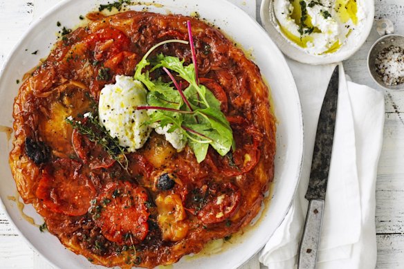 Tomato tarte tatin served with goat's curd and salad leaves.