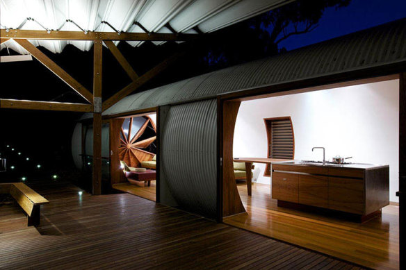 The living and sleeping pods at the Drewhouse are separated for privacy but connected by a wooden covered walkway.