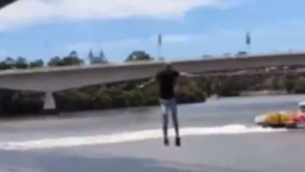 YouTube prankster Luke Erwin jumps into the Brisbane River from the Goodwill Bridge.