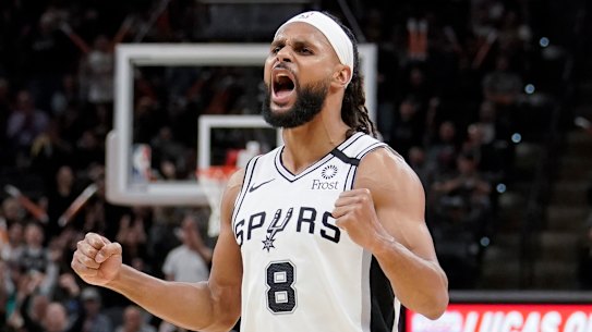 Patty Mills celebrates a basket against the Heat.