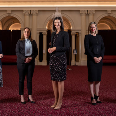 Ali Cupper, Bridget Vallence, Ellen Sandell, Steph Ryan and Gabrielle Williams in the Queen’s Hall at Parliament, surrounded by portraits of Victoria’s premiers, all but one of whom were male. 