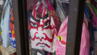 A kabuki face shopping bag inside a closed store at the Ameyoko shopping street in Tokyo.