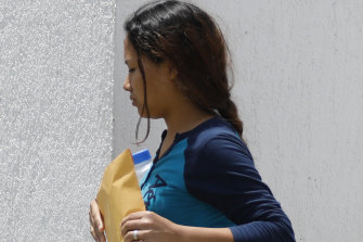 Tania Vanessa Avalos walks between government offices in Matamoros, Mexico, as she completes paperwork necessary for the bodies of her husband Oscar Alberto Martinez Ramírez, 25, and their nearly two-year-old daughter Valeria to be returned home to El Salvador.