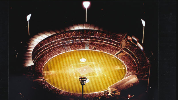 Floodlights illuminate the MCG as more than 79,000 spectators take their seats for the first night final.  