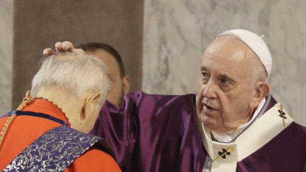Pope Francis puts ashes on the forehead of Cardinal Jozef Tomko in the Santa Sabina Basilica during the Ash Wednesday Mass opening Lent, the forty-day period of abstinence and deprivation for Christians before Holy Week and Easter.