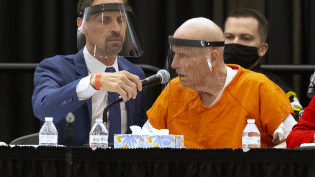 Joseph Cress, left, the public defender for Joseph James DeAngelo, charged with being the Golden State Killer, adjusts the microphone for his client during a hearing in Sacramento Superior Court in Sacramento, California. 