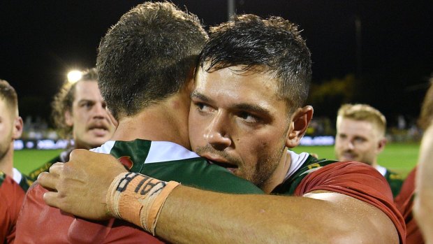 Heavy heart: Braidon Burns embraces Souths captain Sam Burgess after the Charity Shield.