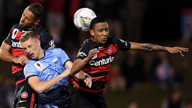 Stepping up: Keanu Baccus tussles with Sydney's Trent Buhagiar in the FFA Cup Derby.
