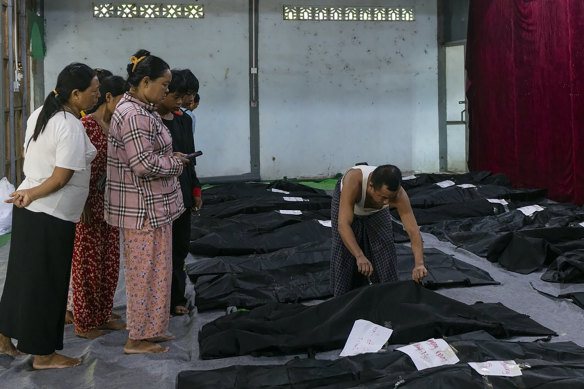 Family members check the bodies of relatives before burials at a hospital in the town of Laiza, Myanmar.
