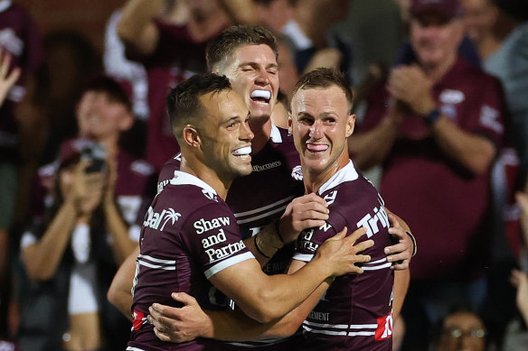 The Sea Eagles celebrate one of Reuben Garrick’s four tries against Canberra.