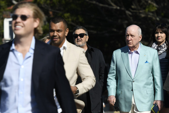 Alan Jones boarding a yacht at Rose Bay Wharf, with Wallaby Kurtley Beale ahead of him on Friday.