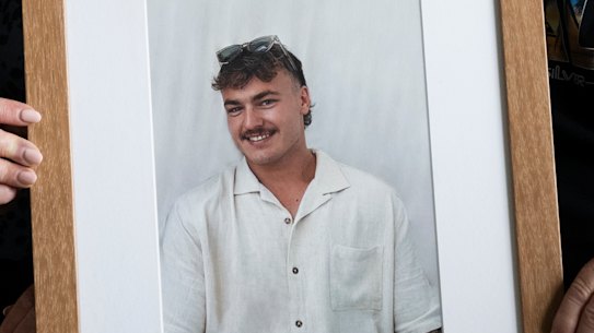 Stacey Chater with her husband Ralph with a photo of their son Brayden. They are coming up to their second Christmas without her son Brayden, who died suddenly after contracting meningococcal B. December 19, 2023. Photo: Louise Kennerley SMH