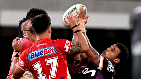 Tristan Sailor of the Broncos and Hamiso Tabuai-Fidow of the Dolphins compete for the ball during the Battle of Brisbane at The Gabba on Saturday.