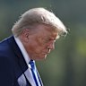 US President Donald Trump walks away following the group photograph at the G7 Summit in Alberta.
