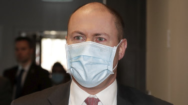Treasurer Josh Frydenberg arrives wearing a mask for his address to the National Press Club of Australia in Canberra on Friday.