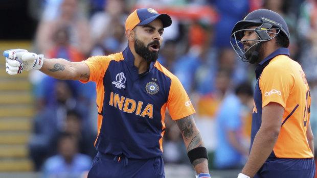 Unimpressed: India captain Virat Kohli speaks with Rohit Sharma after hitting a four against England. He called the short boundary at Edgbaston that played into the hands of the home side "bizarre".
