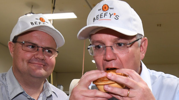 Scott Morrison eats a pie during a visit to the Beefy's Pies factory near Maroochydore.
