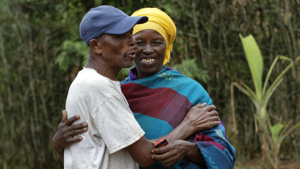 Genocide survivor Laurencia Mukalemera, a Tutsi, greets Tasian Nkundiye, a Hutu who murdered her husband and spent eight years in prison for the killing and other crimes, at Nkundiye's home in the reconciliation village of Mbyo, near Nyamata, in Rwanda. 