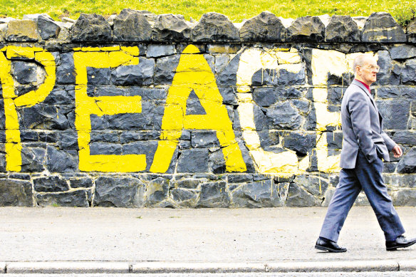 A man passes a peace message in May 1998 on the day of a referendum to approve the Good Friday Agreement. 
