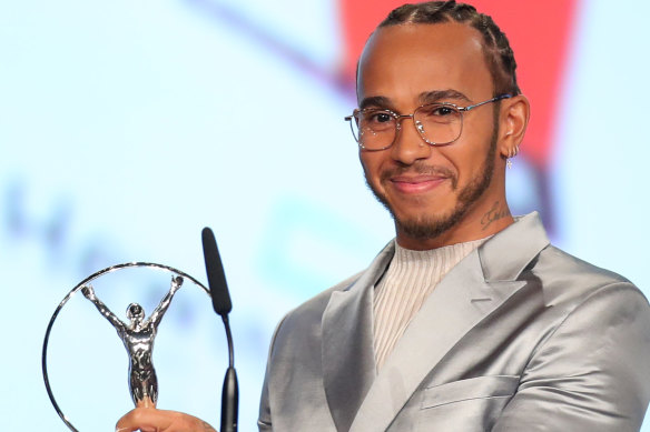Laureus World Sportsman of the Year British F1 driver Lewis Hamilton poses with his award during the 2020 Laureus World Sports Awards .