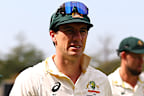 Pat Cummins leads the Australian team off the field.