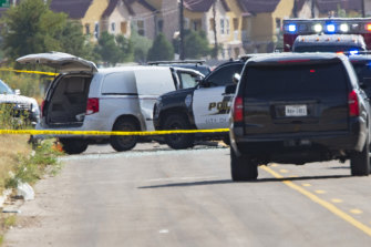 Odessa and Midland police and sheriff's deputies surround a white van in Odessa, Texas, following the shooting.