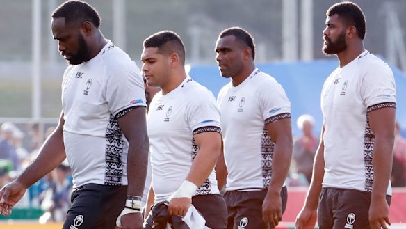 Shellshocked Fijian players leave the field after Wednesday's shock World Cup loss to Uruguay.