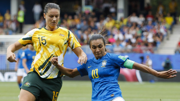 Australia's Emily Gielnik tussles with Brazilian legend Marta.