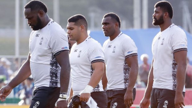 Shellshocked Fijian players leave the field after Wednesday's shock World Cup loss to Uruguay.