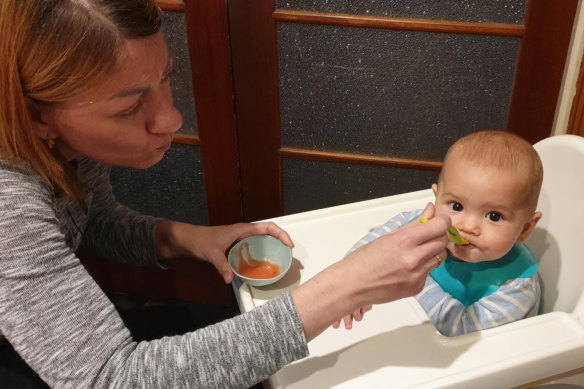 Yana Shyshko, feeding the Pilcher-Shyshko household’s youngest resident, Eli Pilcher, 7 months.