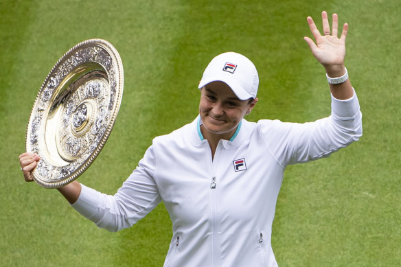Ash Barty lifts the trophy after winning Wimbledon.