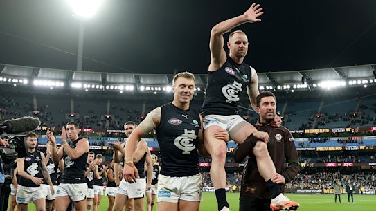 Carlton’s Sam Docherty is chaired off the ground after his final game.