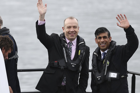 Britain’s Prime Minister and Conservative Party leader Rishi Sunak, right, and Britain’s Northern Ireland Secretary Chris Heaton-Harris wait on board an Artemis Technologies boat before a tour during a visit to the maritime technology centre at a dockyard in Belfast, on Friday.